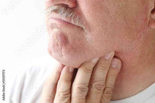 Photo: closeup of man with sore throat closeup of man with sore throat