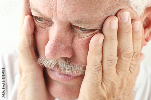 Photo: older man holds both hands up to his face older man holds both hands up to his face