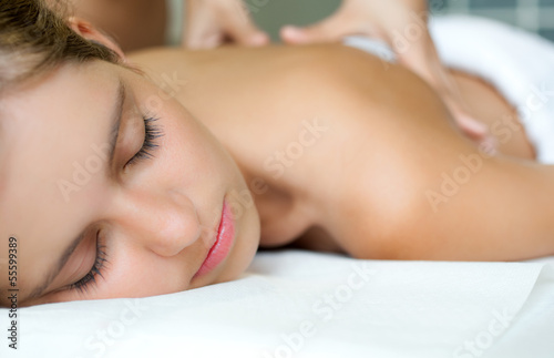 Photo: Relaxed woman receiving a massage in a spa Relaxed woman receiving a massage in a spa