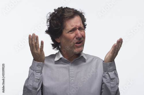 Photo: Exasperated man with hands in air, horizontal Exasperated man with hands in air, horizontal