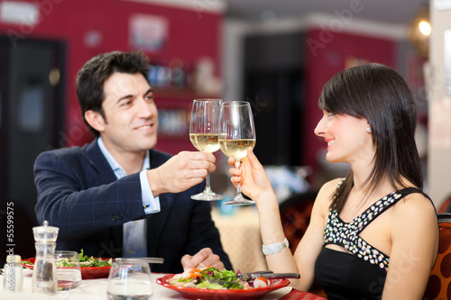 Photo: Couple toasting wineglasses in a luxury restaurant Couple toasting wineglasses in a luxury restaurant