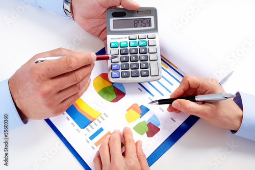 Photo: Hands of business people with calculator. Hands of business people with calculator.