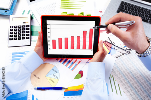 Photo: Business team working with tablet computer. Business team working with tablet computer.