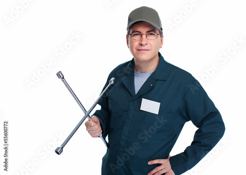 Photo: Auto mechanic with a wheel wrench. Auto mechanic with a wheel wrench.