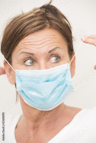 Photo: Woman nurse/doctor with mask over face Woman nurse/doctor with mask over face