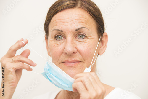 Photo: Female nurse with mask on white Female nurse with mask on white