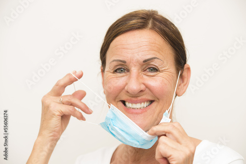 Photo: Cheerful female nurse with mask Cheerful female nurse with mask
