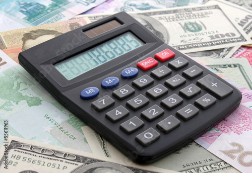 Photo: calculating cash: calculator on banknotes calculating cash: calculator on banknotes
