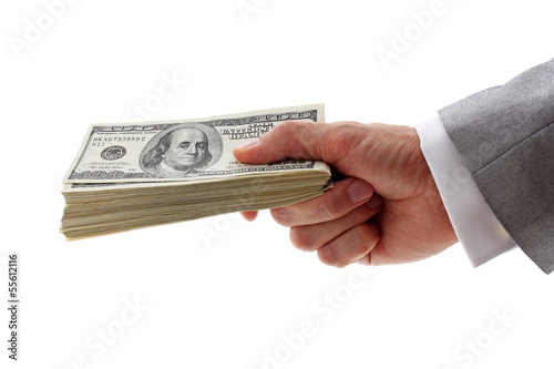 Photo: hand of businessman holding pile of dollars hand of businessman holding pile of dollars