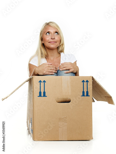 Photo: Pretty young woman stting in her moving box Pretty young woman stting in her moving box