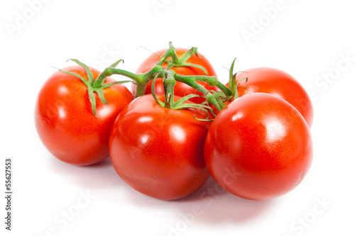Photo: Closeup of tomatoes on the vine isolated on white. Tomato branch Closeup of tomatoes on the vine isolated on white. Tomato branch