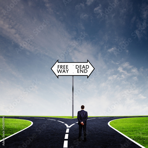 Photo: Businessman at crossroads Businessman at crossroads