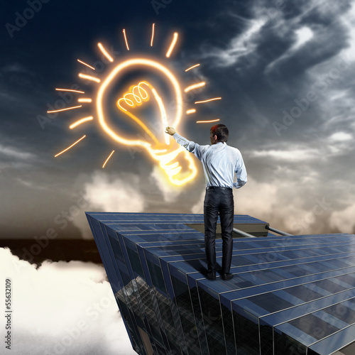 Photo: Businessman drawing bulb Businessman drawing bulb