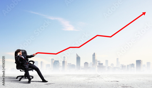 Photo: Businessman pulling graph Businessman pulling graph