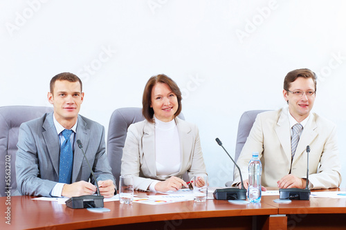 Photo: Three businesspeople at meeting Three businesspeople at meeting