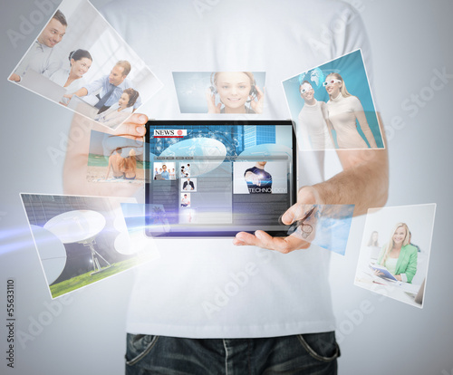 Photo: man showing tablet pc with news man showing tablet pc with news