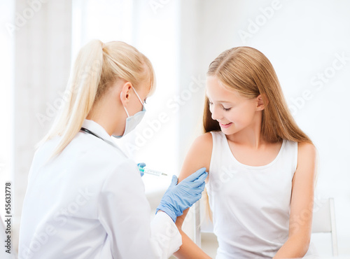 Photo: doctor doing vaccine to child in hospital doctor doing vaccine to child in hospital