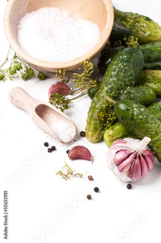 Photo: Pickled cucumber over white Pickled cucumber over white