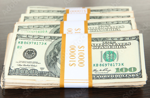 Photo: Stacks of money on wooden table Stacks of money on wooden table