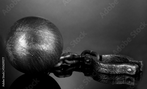 Photo: Ball and chain on grey background Ball and chain on grey background