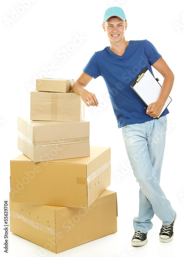Photo: Young delivery man with parcels and clipboard, isolated on Young delivery man with parcels and clipboard, isolated on