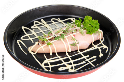 Photo: Raw chicken fillets on dripping pan, isolated on white Raw chicken fillets on dripping pan, isolated on white