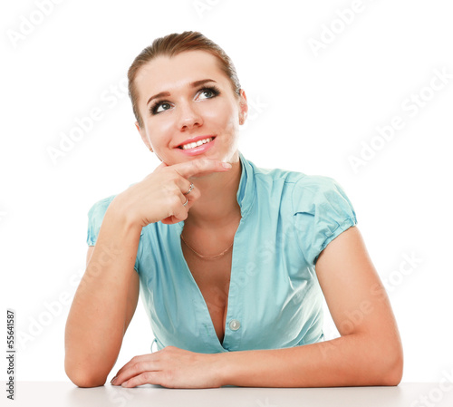 Photo: A young woman sitting isolated on white background A young woman sitting isolated on white background