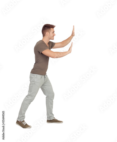 Photo: Young man pushing something Young man pushing something