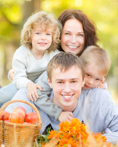 Photo: Happy family in autumn park Happy family in autumn park