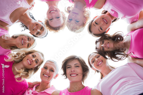 Photo: Group of happy women in circle wearing pink for breast cancer Group of happy women in circle wearing pink for breast cancer
