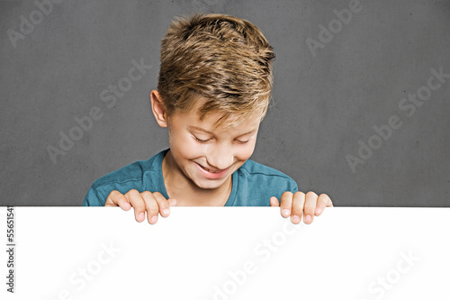 Photo: Child looking over white Wall Child looking over white Wall