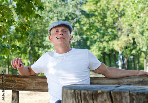 Photo: Man puffing on a cigarette Man puffing on a cigarette