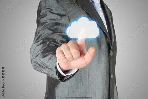 Photo: Businessman pushes virtual cloud button Businessman pushes virtual cloud button