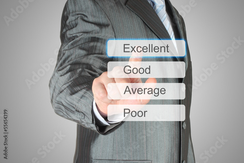 Photo: Businessman pushing virtual excellent button on grey background. Businessman pushing virtual excellent button on grey background.