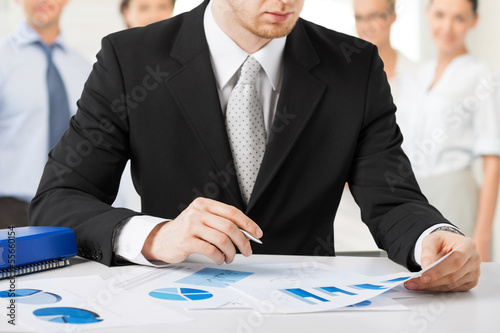 Photo: businessman working with papers businessman working with papers