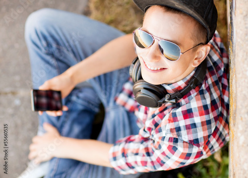 Photo: girl with headphones and smartphone girl with headphones and smartphone
