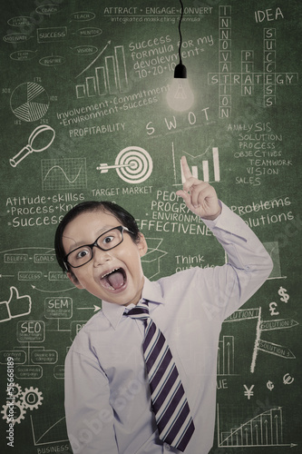 Photo: Little businessman has idea in class Little businessman has idea in class