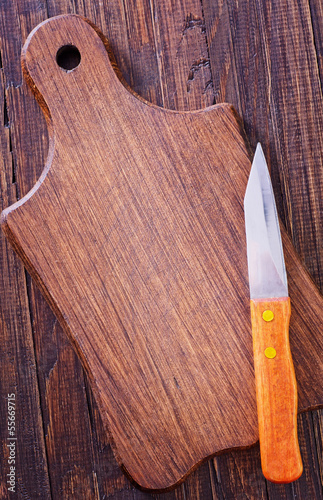 Photo: knife on wooden board knife on wooden board
