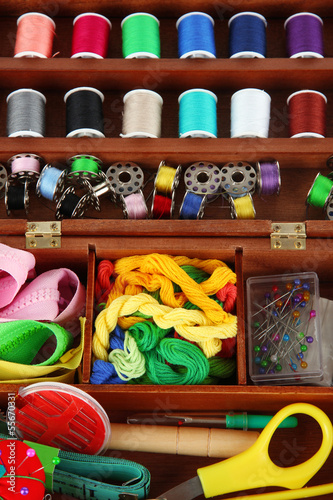 Photo: Sewing kit in wooden box close-up Sewing kit in wooden box close-up