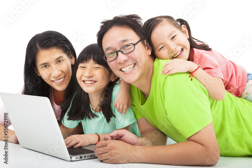 Photo: happy asian family with laptop happy asian family with laptop