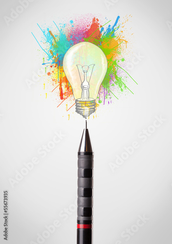Photo: Pen close-up with colored paint splashes and lightbulb Pen close-up with colored paint splashes and lightbulb