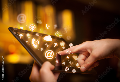 Photo: Hand touching tablet pc, social media concept Hand touching tablet pc, social media concept