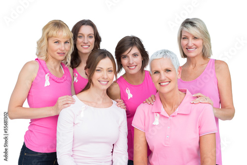 Photo: Happy women posing and wearing pink for breast cancer Happy women posing and wearing pink for breast cancer
