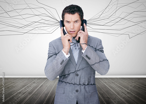 Photo: Businessman trapped by telephone wires Businessman trapped by telephone wires