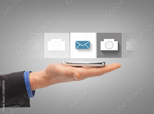 Photo: hand with smartphone showing application hand with smartphone showing application