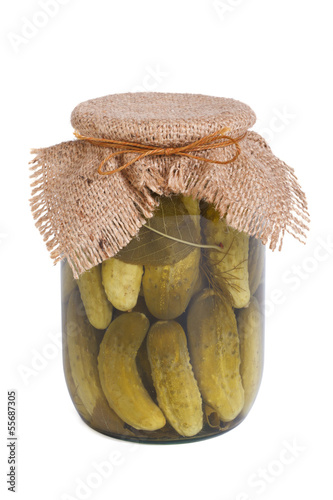 Photo: Pickled cucumbers in glass jar isolated us white background Pickled cucumbers in glass jar isolated us white background
