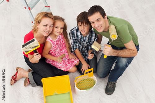 Photo: Happy family redecorating their home - painting Happy family redecorating their home - painting