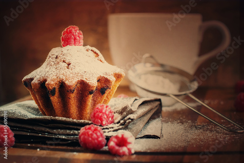Photo: Fruitcake Decorated with Raspberry and icing sugar at the wooden Fruitcake Decorated with Raspberry and icing sugar at the wooden