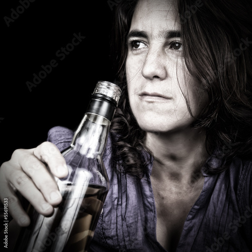 Photo: Drunk latin woman drinking from a whiskey bottle Drunk latin woman drinking from a whiskey bottle