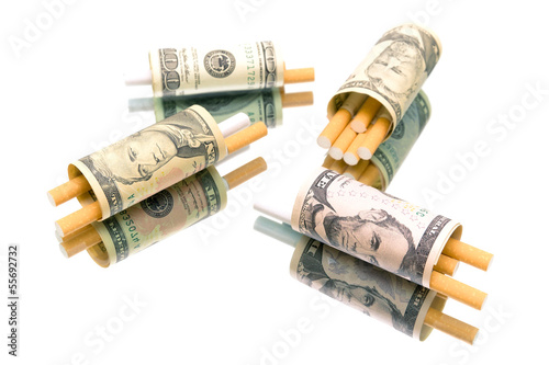 Photo: money and cigarettes on white background money and cigarettes on white background